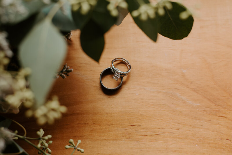 detail photo of wedding rings and eucalyptus, photo inspiration for your intimate wedding day