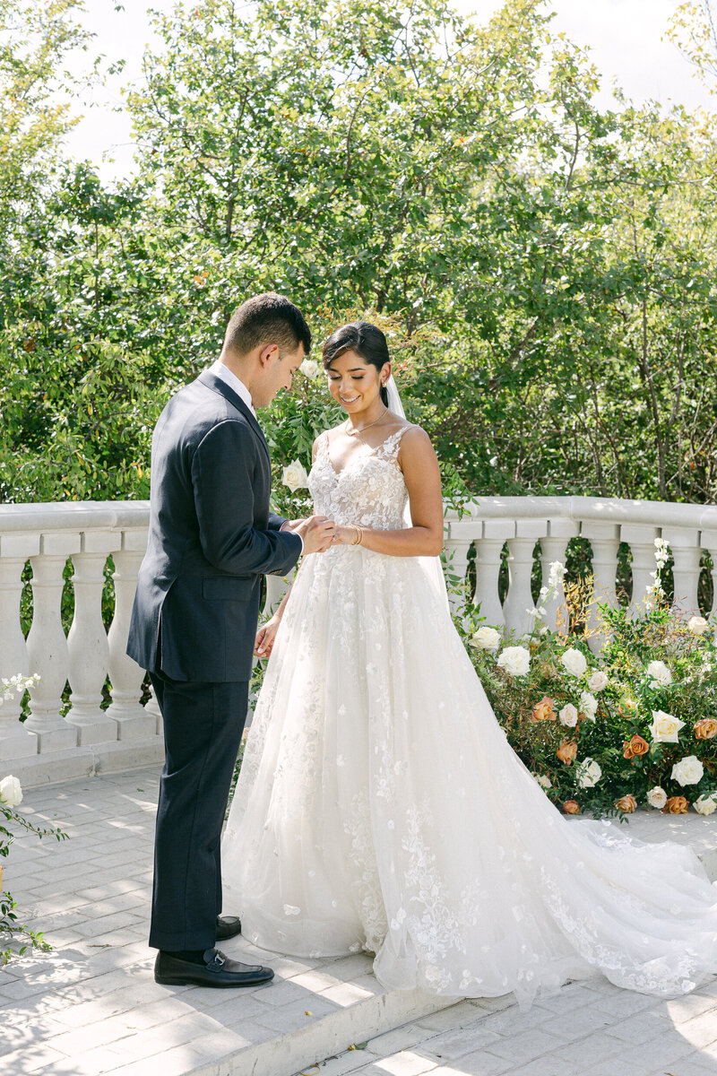 a bride and groom holding hands during a private moment