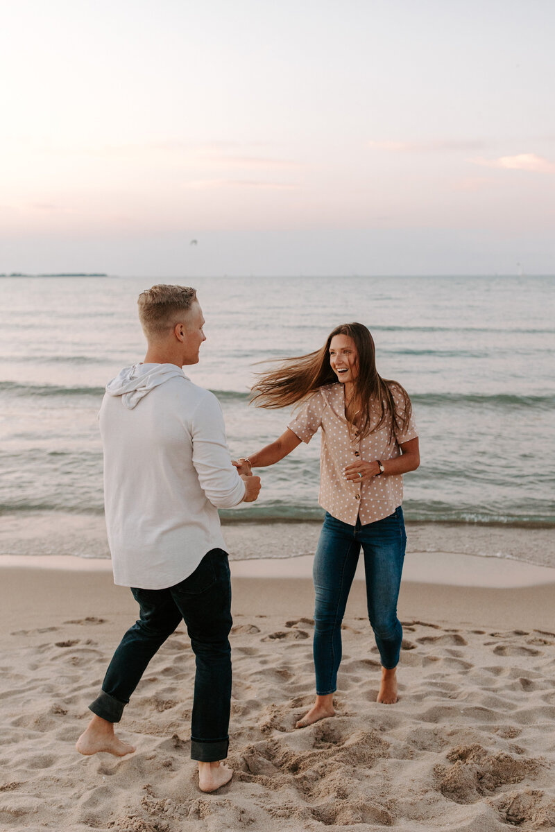 couple spinning on beach