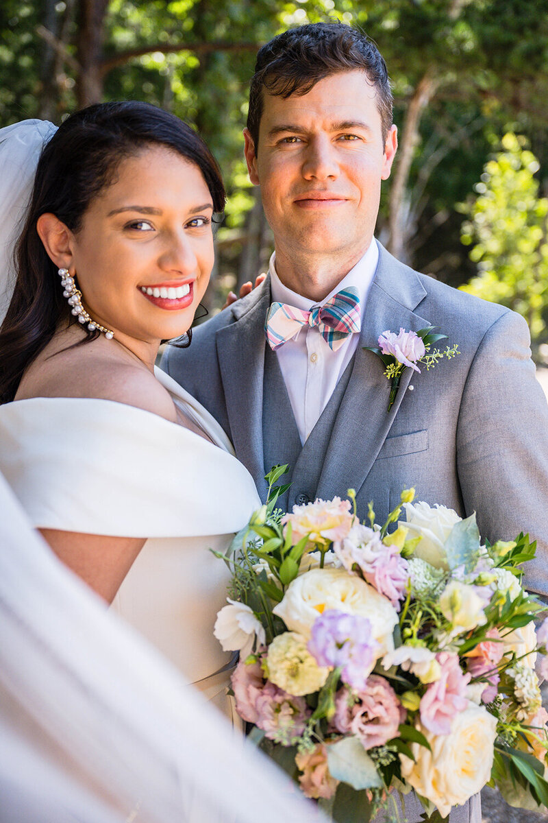 A couple stand together for a photo on their elopement day at Carvin's Cove in Roanoke, Virginia.