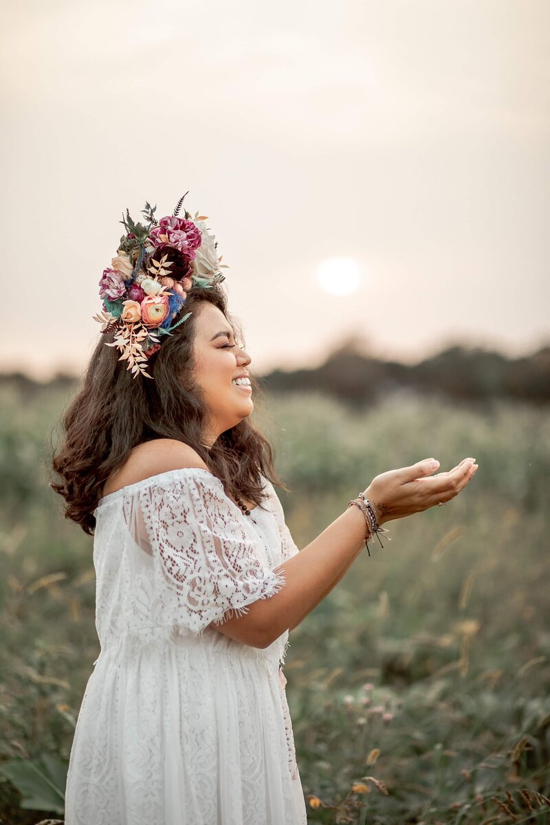 happy woman in a white dress and flower crown
