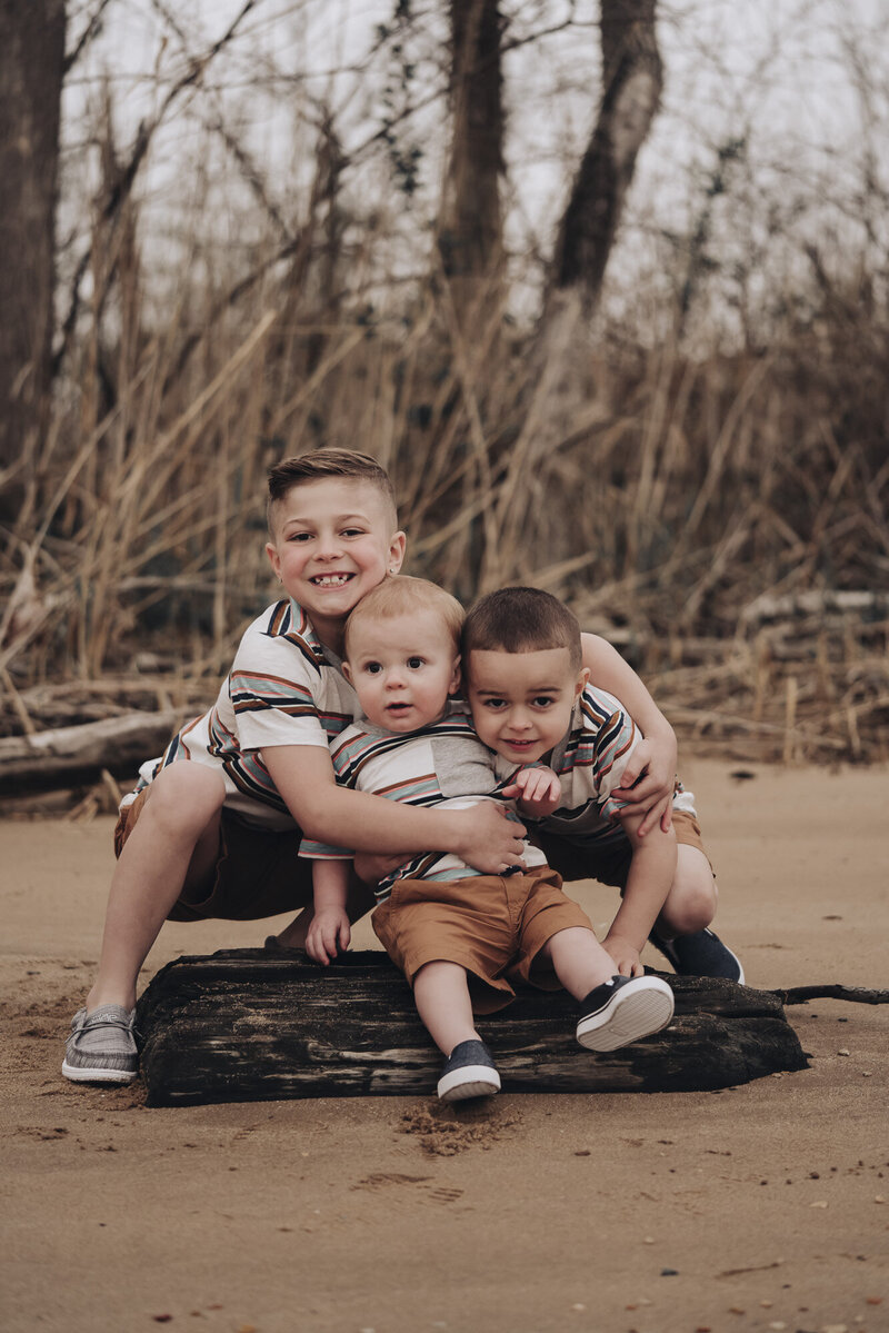 Boys sitting on a beach together