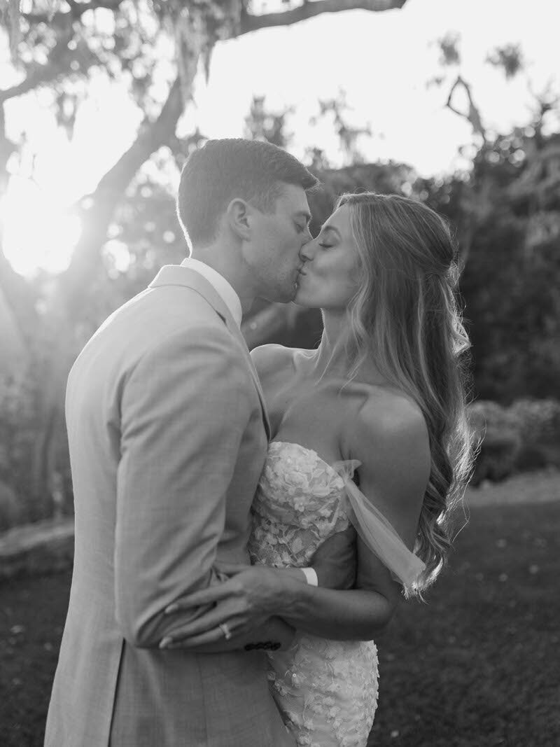 Black and white photo of bride and groom kissing at an intimate destination wedding
