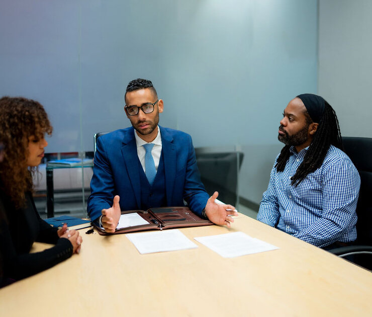 Central Ohio family law attorney meeting with a couple to provide alternative dispute resolution services, discussing solutions in a professional setting