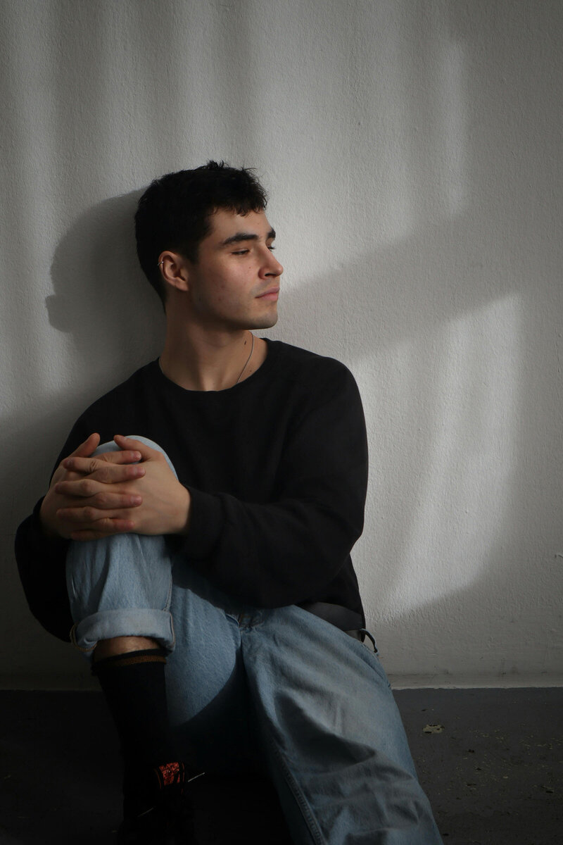 Self-portrait on a blank wall with shadows