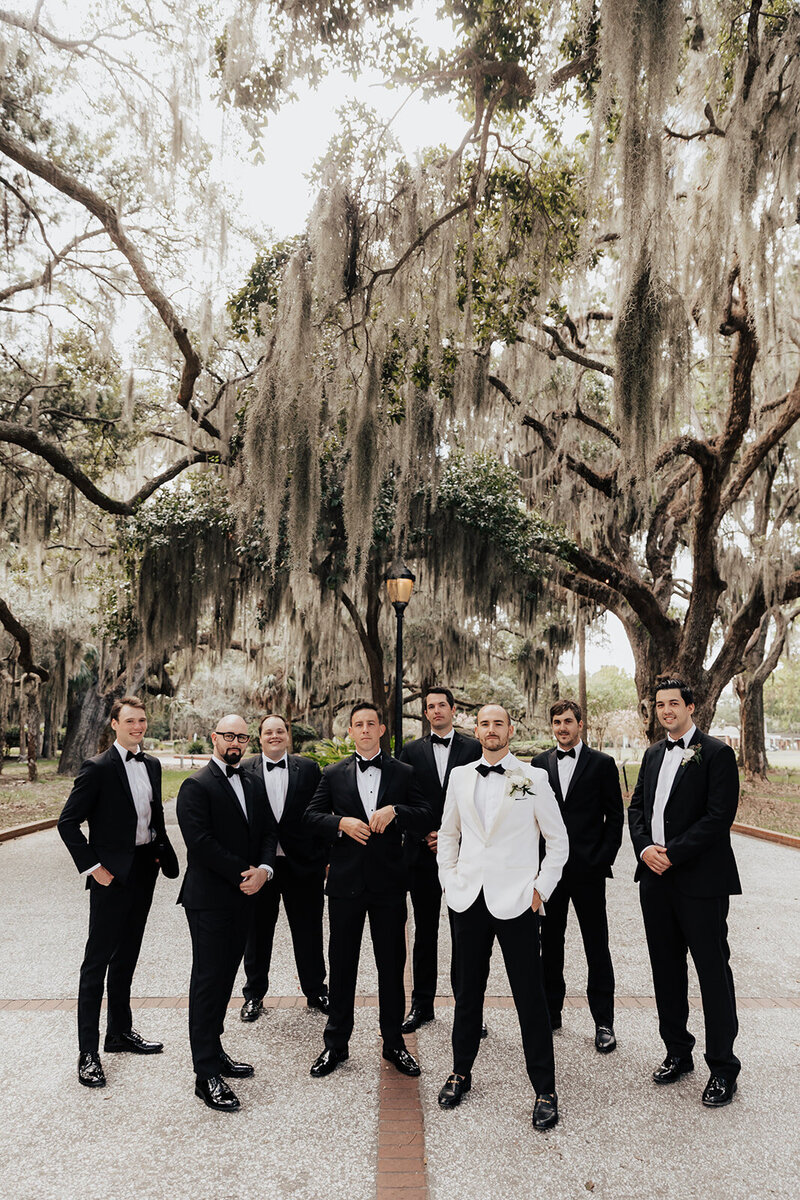 Group photo of groomsmen with oaks and spanish moss in background