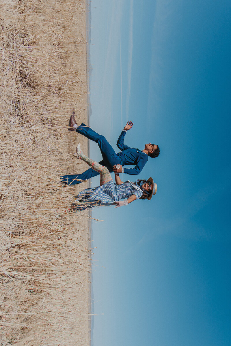 trendy couple walking in desert with blue sky