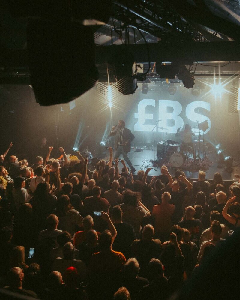Big special lead singer sings in front of cheering crowd