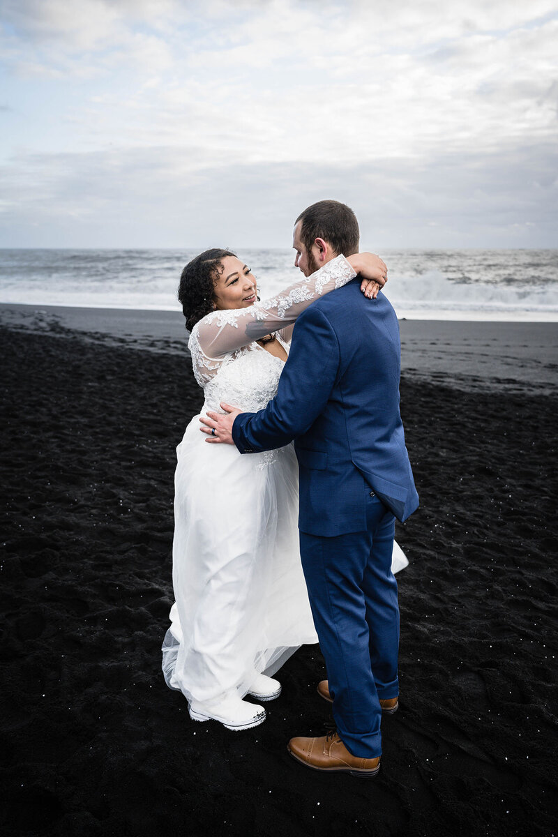 A couple from Roanoke, Virginia on their elopement day take their first dance on the shores of Reynisfjara Beach in Iceland.