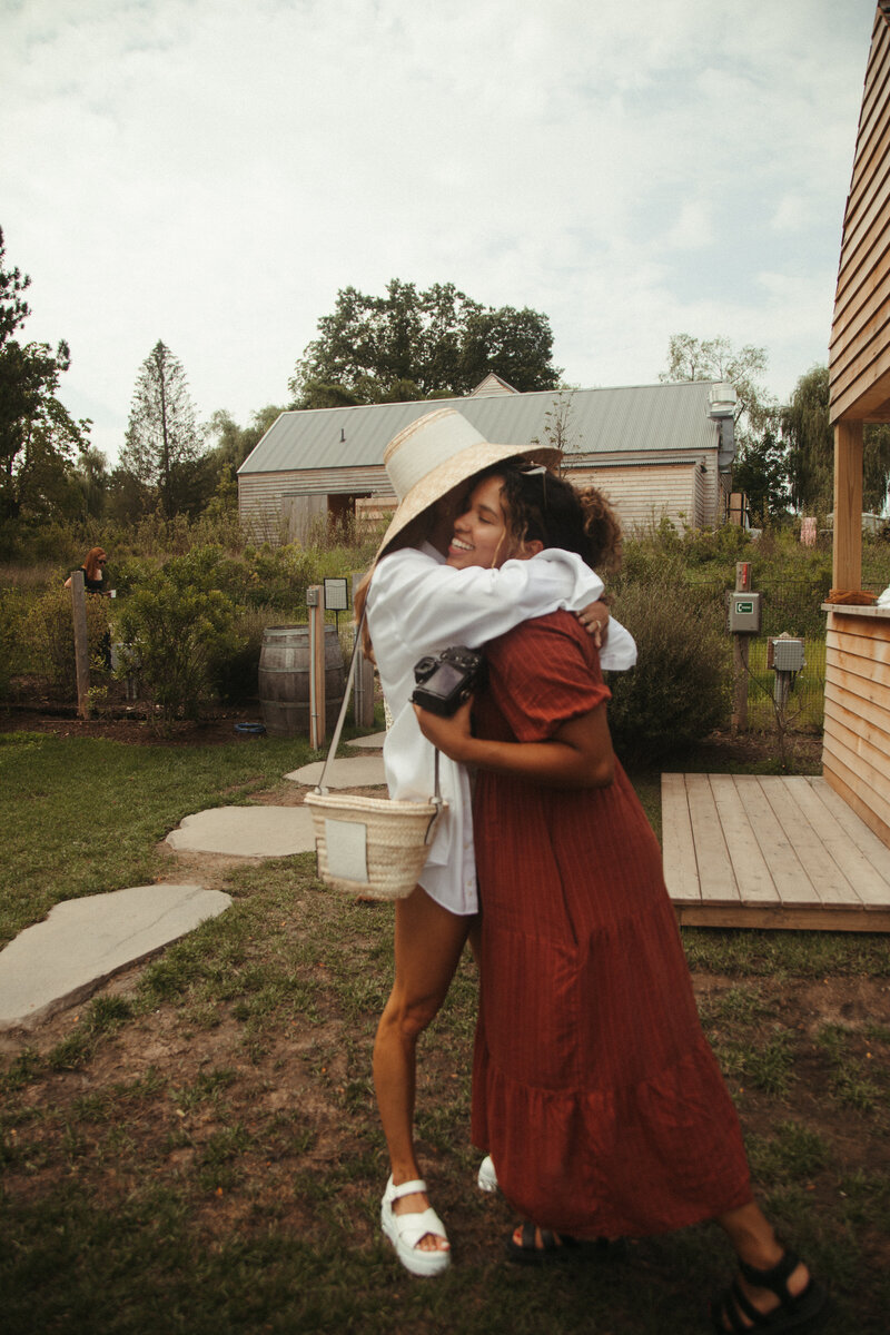 bride and photographer hugging