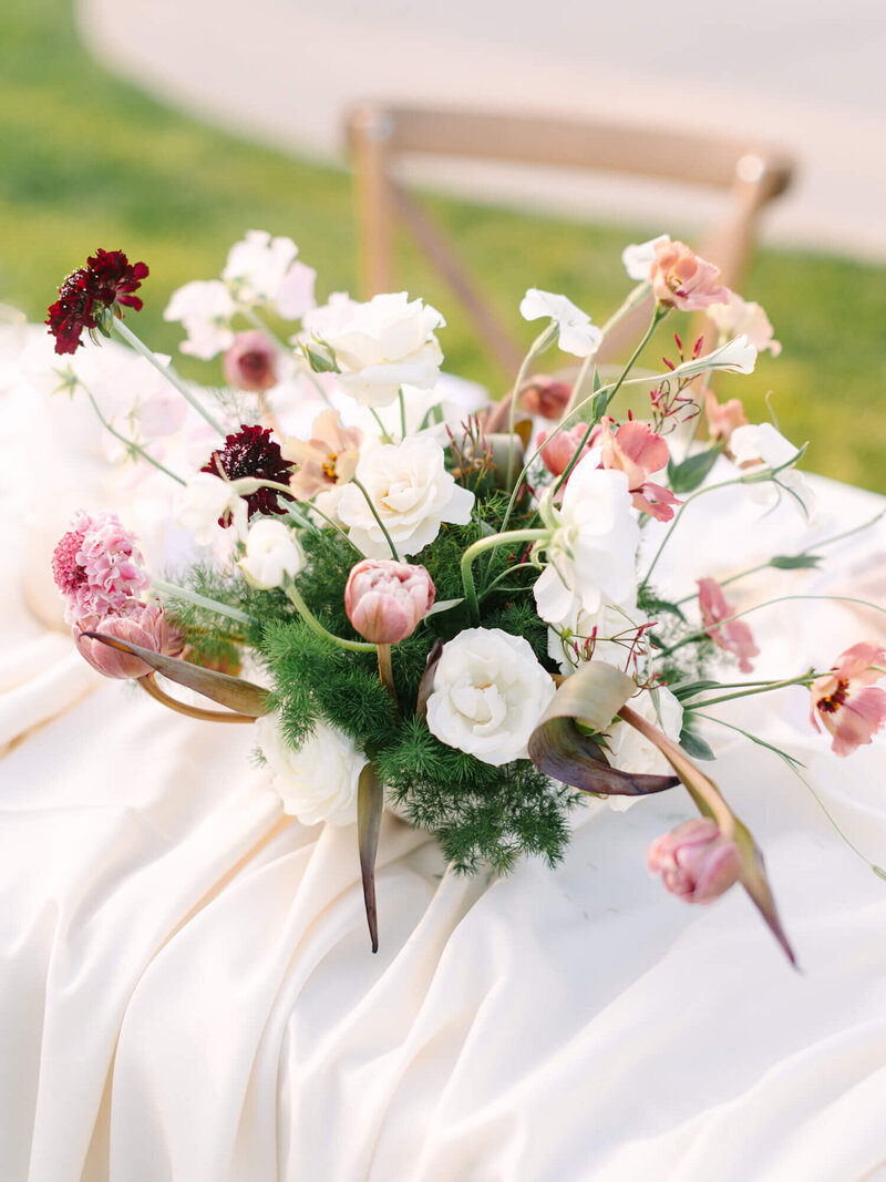 gorgeous arrangement of bouquet  with table draping at reception