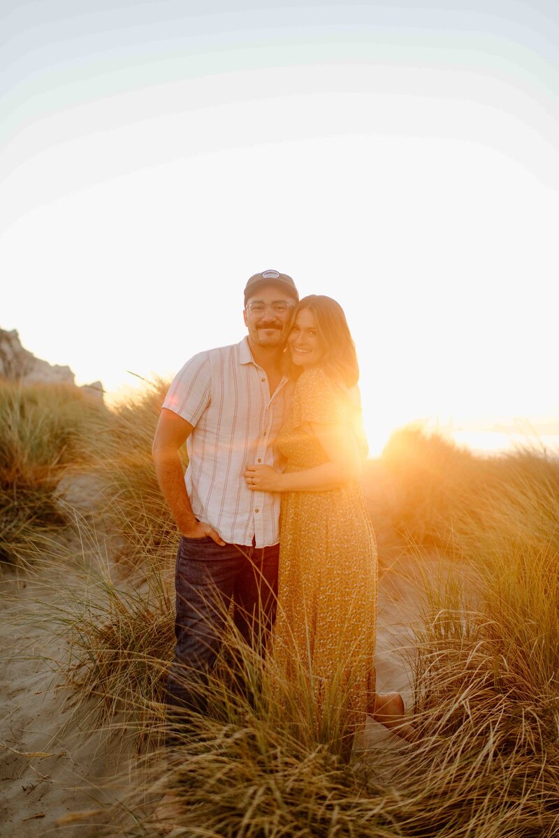 couple kissing in front of home