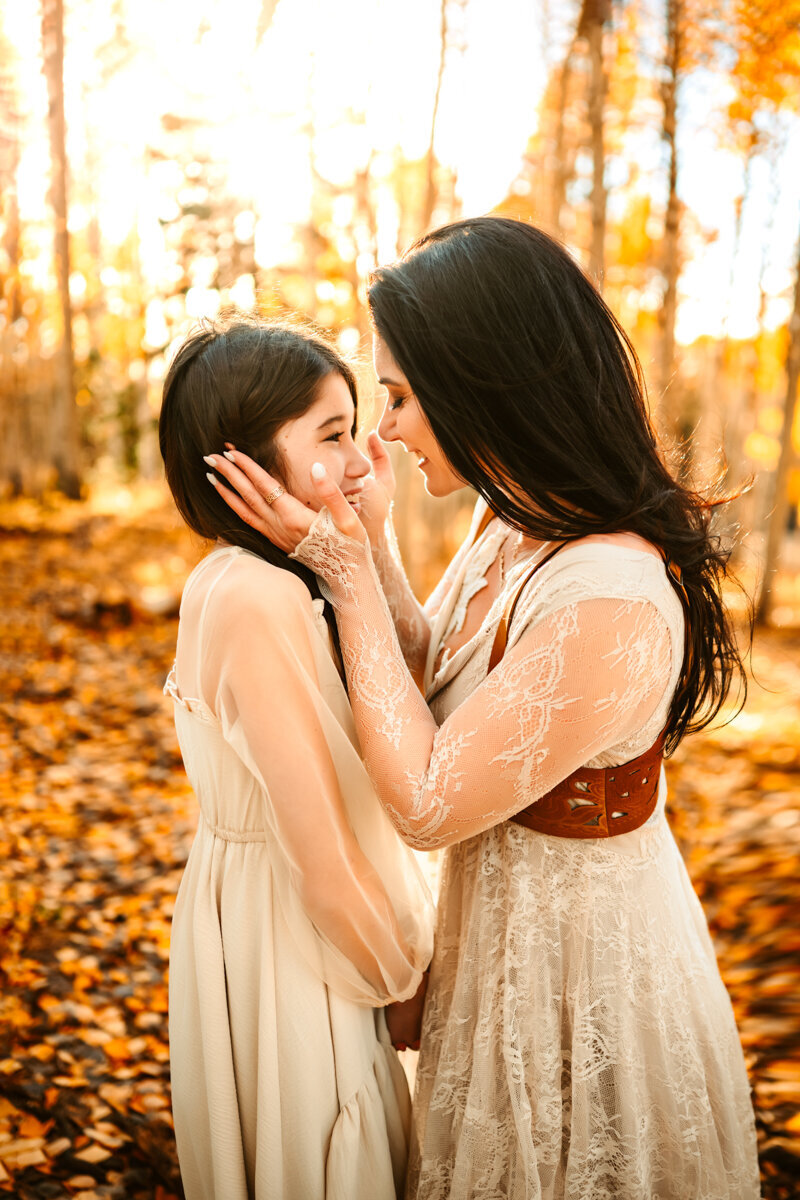 Bell Rock, Sedona mother and daughter hugging at sunset while the cool breeze blows their hair.