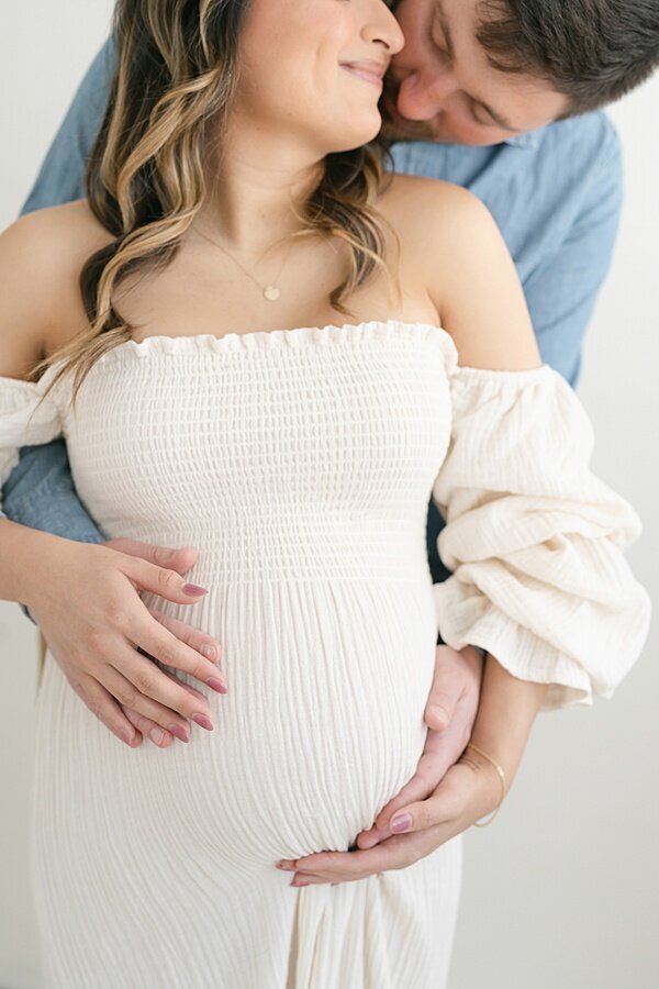 Mama to Be with Husband wearing a peach dress Maternity Photographer Louisville KY
