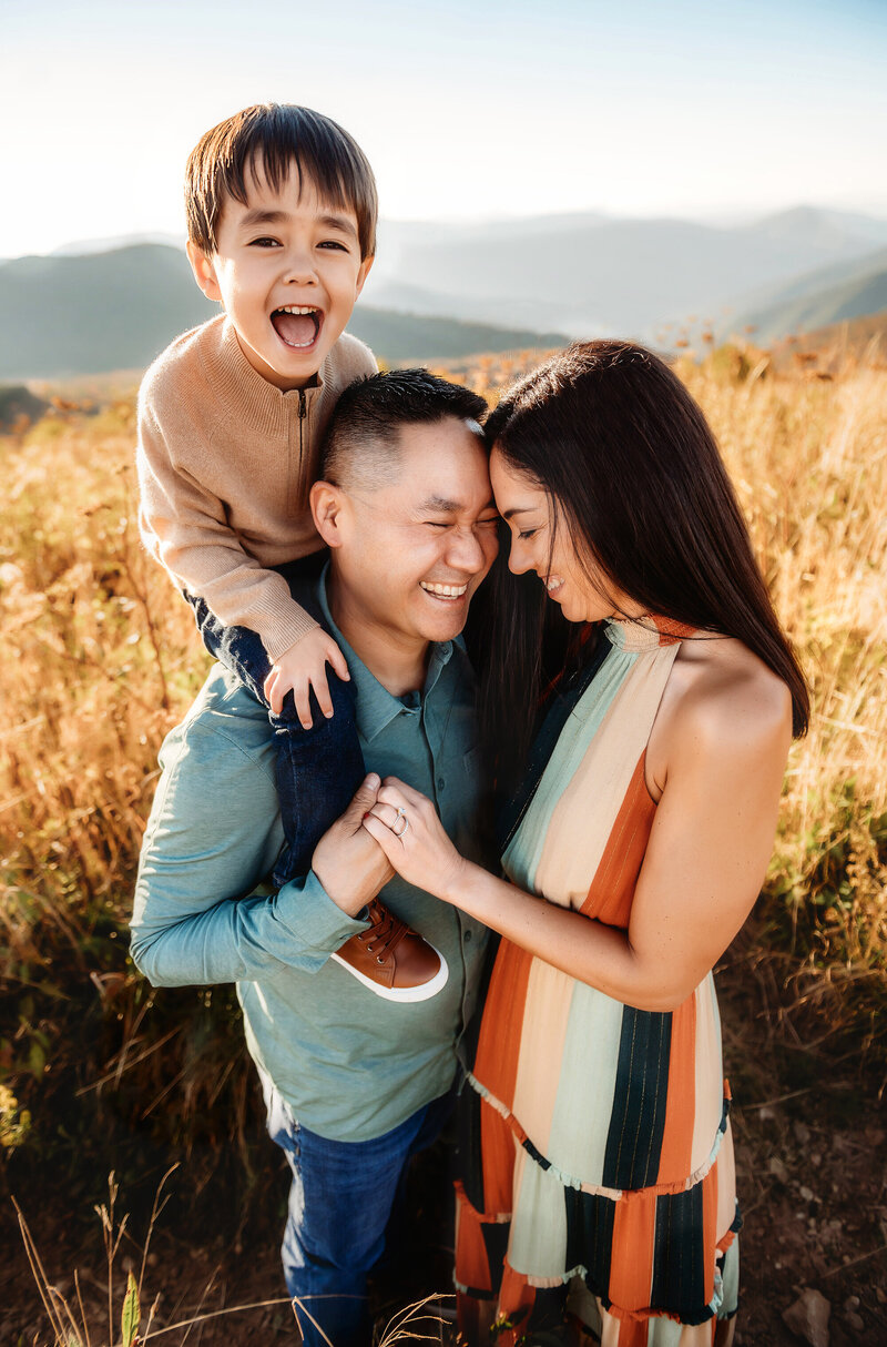 Family embraces each other during Family Photos at Black Balsam on the Blue Ridge Parkway in Asheville, NC.