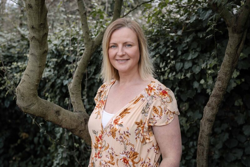 A headshot of Claire O'Brien at sunset