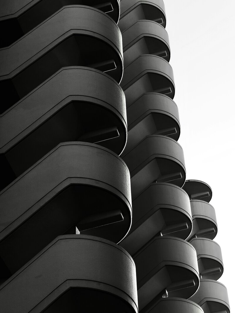 Black and white photo of stacked, curved architectural layers or balconies