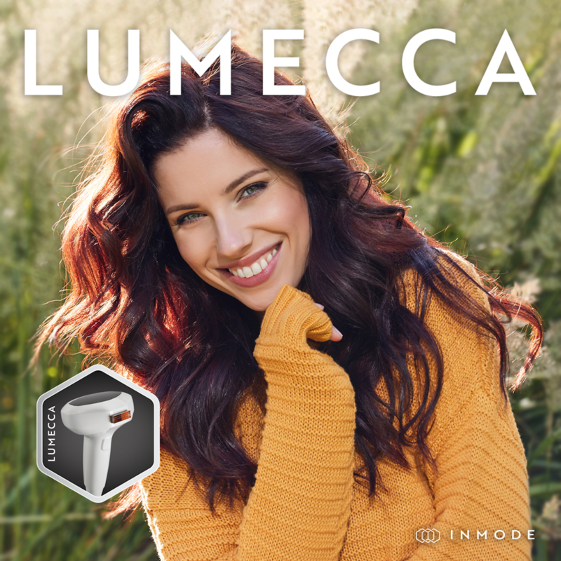 Woman smiling next to IPL device