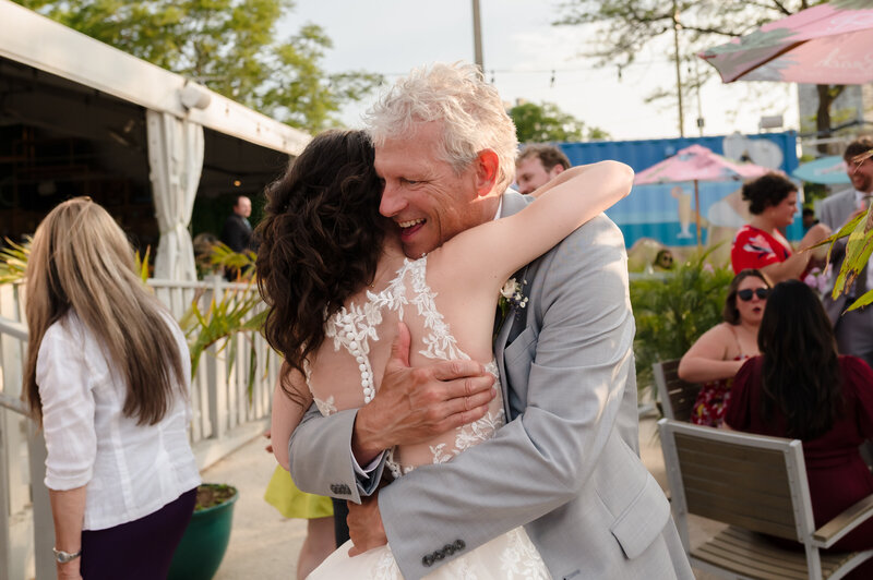 Bride hugs guests during cocktail hour at The Shore Club in Chicago