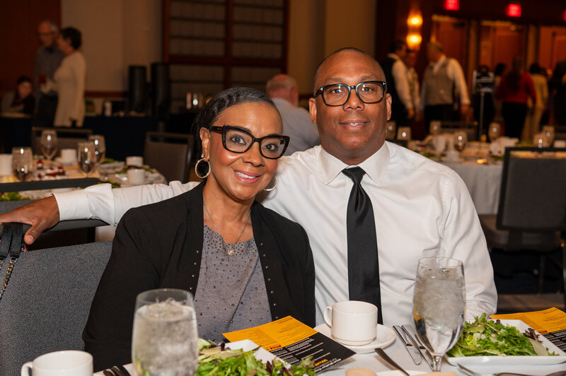 Seated couple at a formal business dinner captured during a corporate event in Phoenix, Arizona by MISGIF event photographers.