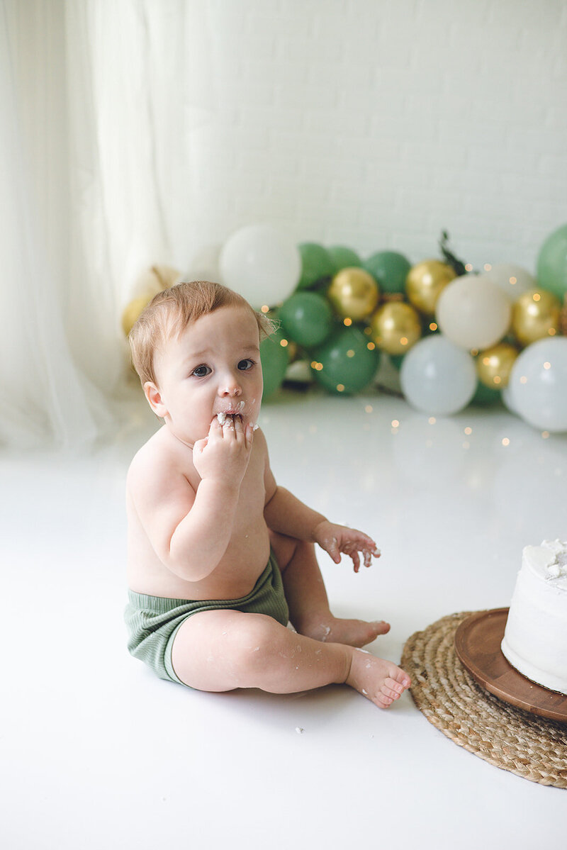 baby boy celebrating first birthday with cake smash in Naples , FL studio