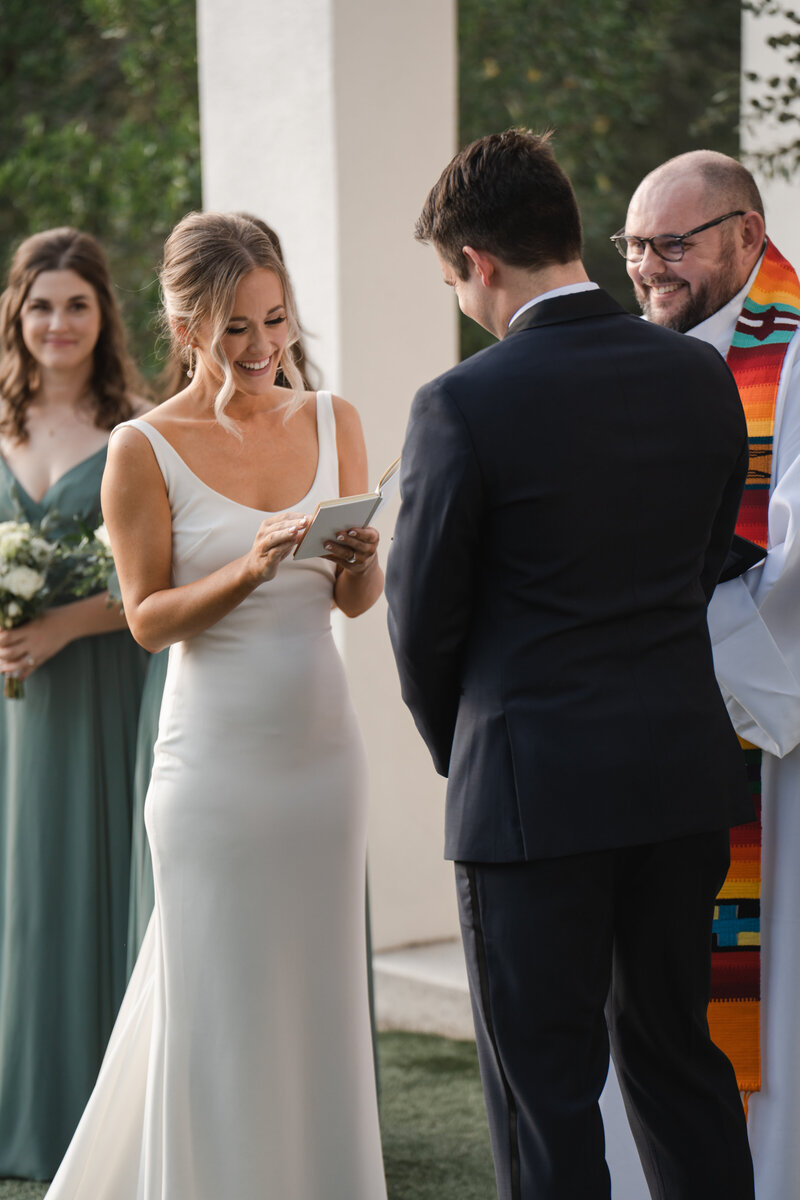 bride reads thoughtful wedding vows to new husband on wedding day