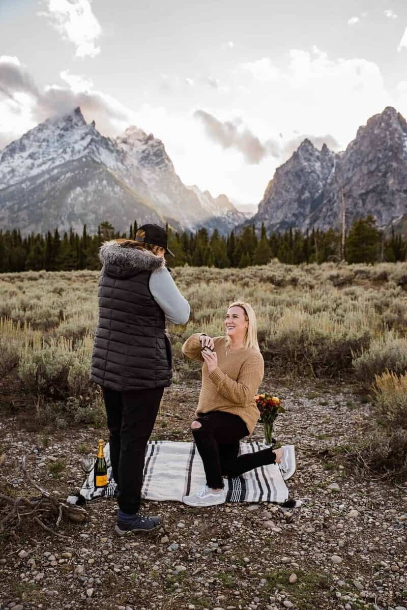 Woman proposing in front of the Grand Tetons