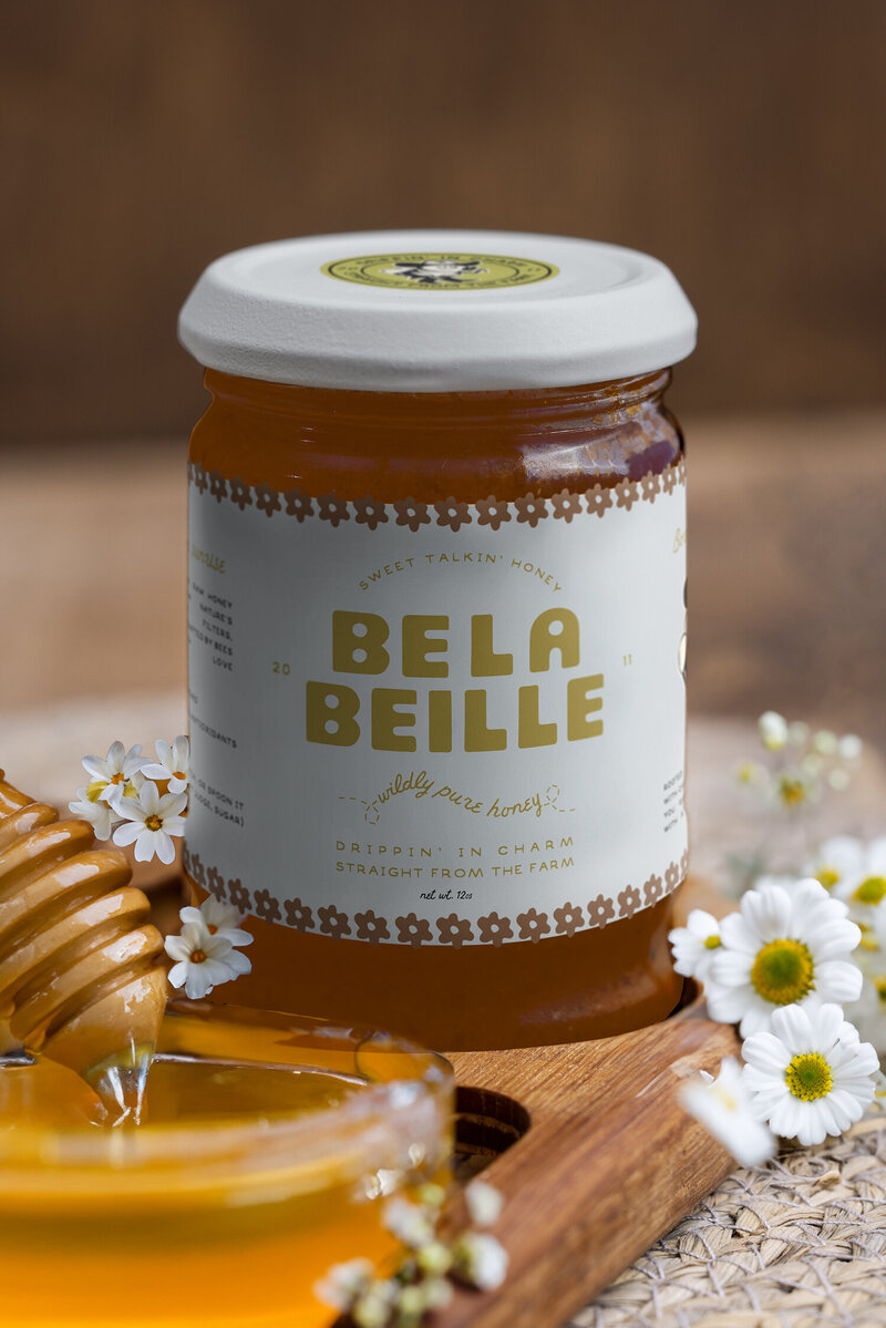 Belabeille’s branding, logo, and packaging were designed to elevate female-led honey brands in the CPG space. The cowgirl bee mascot and southern-inspired visuals create vibrant, retail-ready packaging that captures attention and builds brand loyalty.

Wildspark crafted Belabeille’s logo, packaging, and brand identity to help boutique honey entrepreneurs connect with their audience. Bold, playful design, southern charm, and cowgirl-inspired elements enhance shelf impact and online presence.