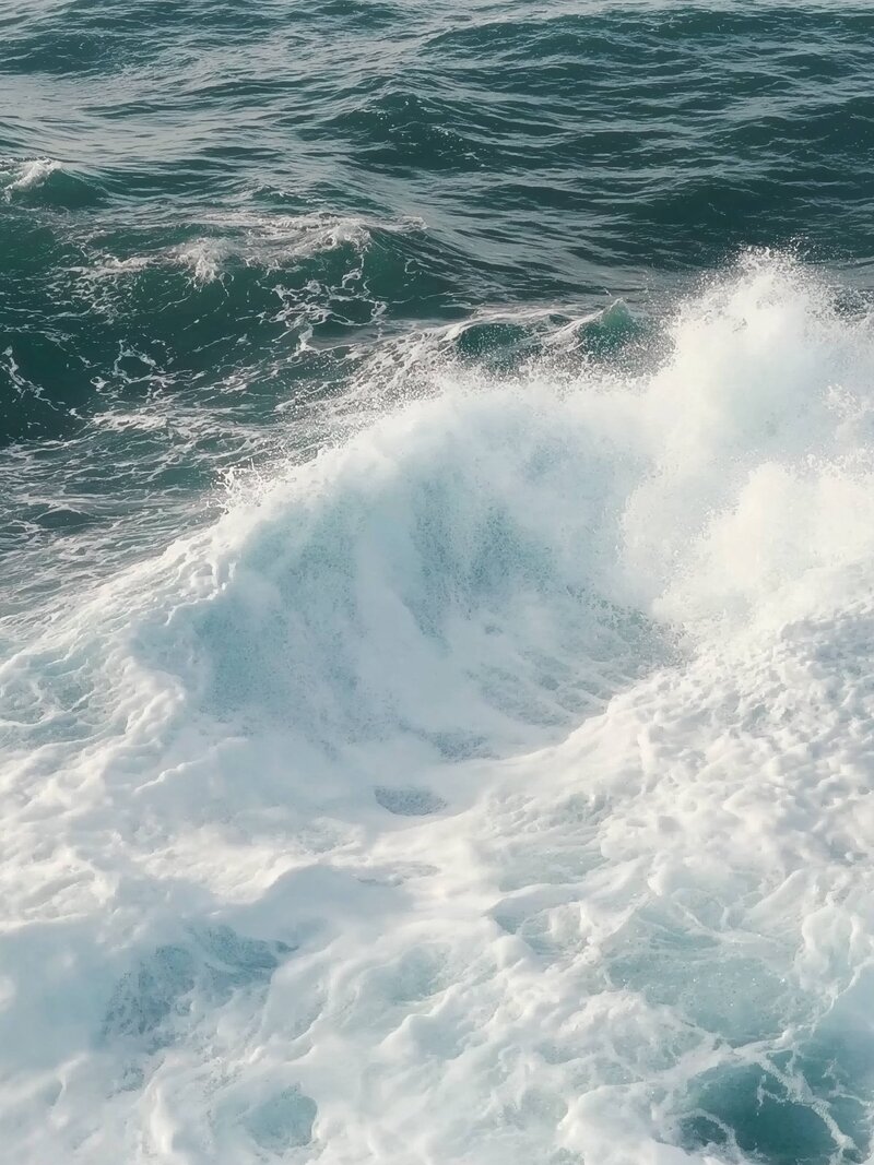 Ocean waves crash one after the other