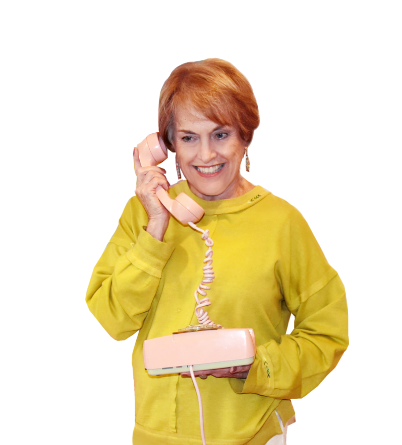 Beth Harkins, author in a yellow shirt talking on a rotary dial phone