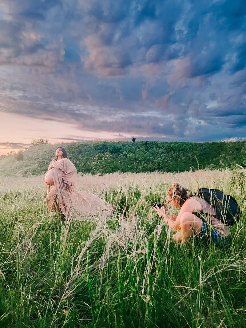 photo of photographer capturing maternity mom at sunset