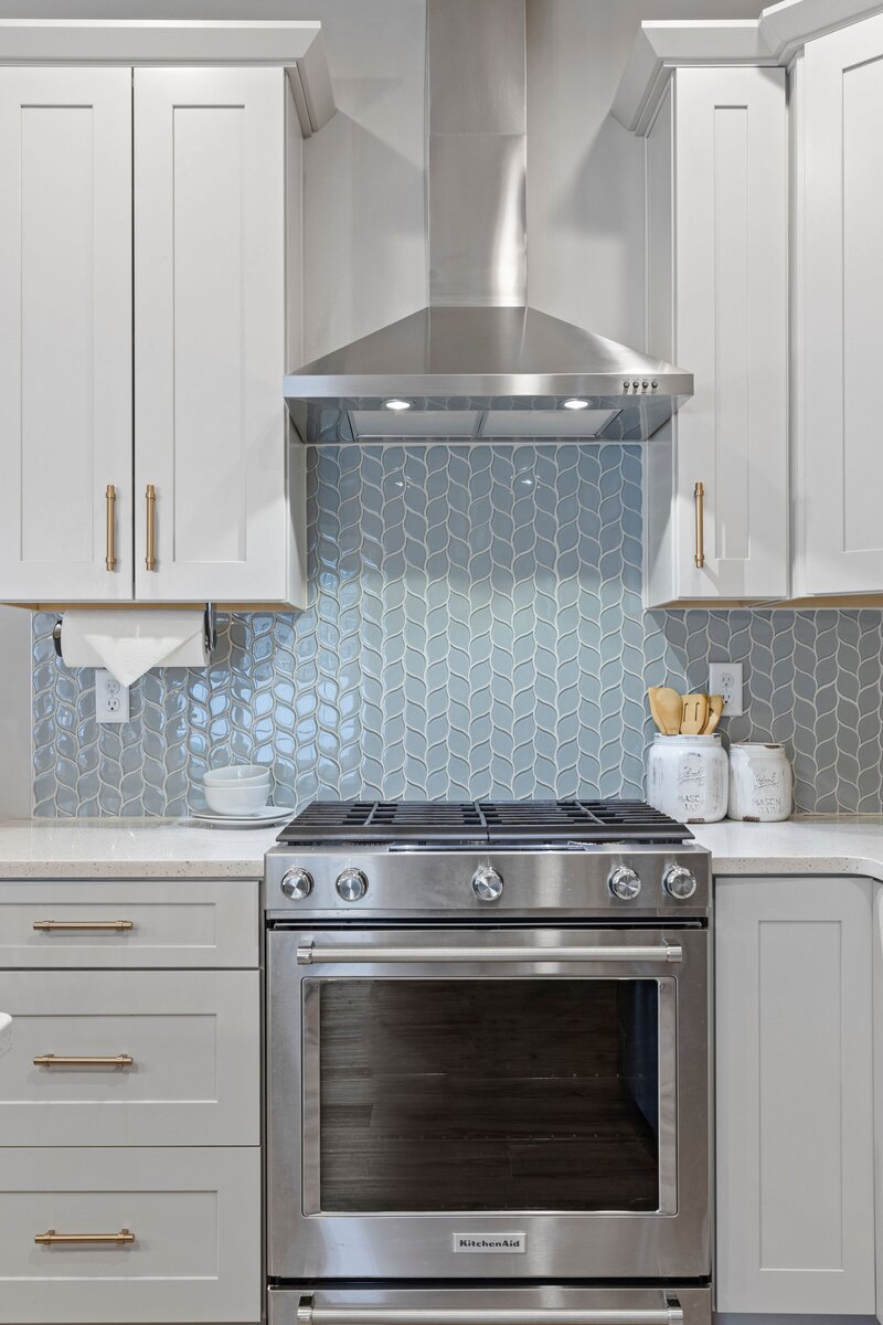 Updated white kitchen with blue tile backsplash