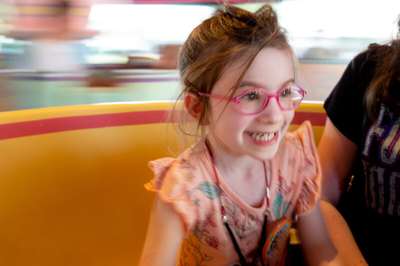 A little girl wearing glasses.