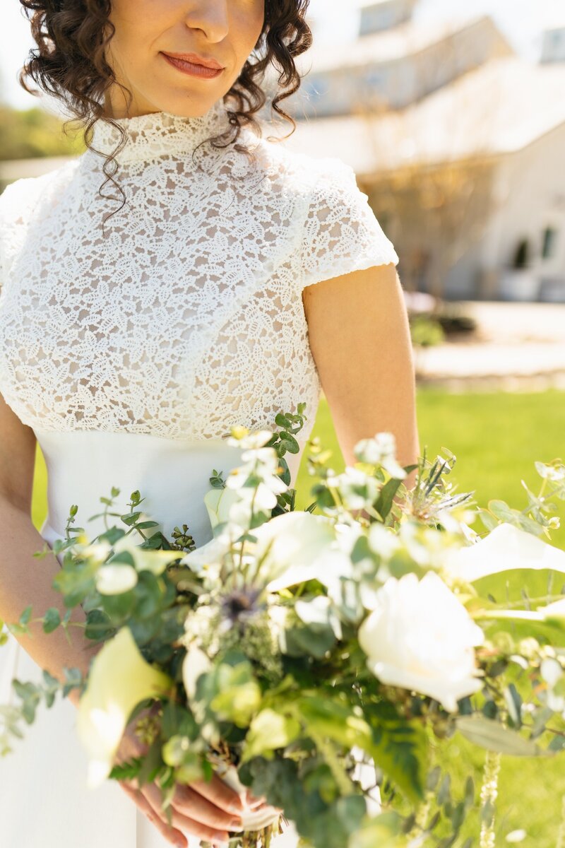 bride holding a white flower bouquet
