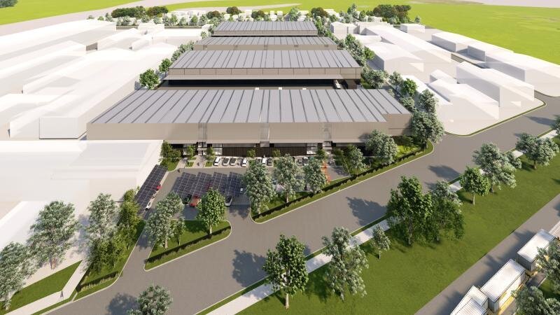 Aerial view of a large-scale industrial warehouse facility surrounded by trees