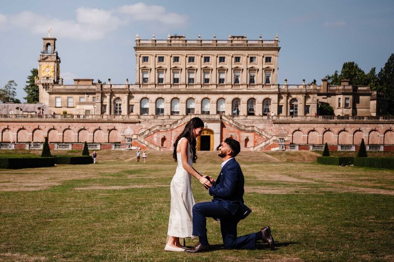 The moment he proposed on the grass with the magnificent Cliveden House in the background.