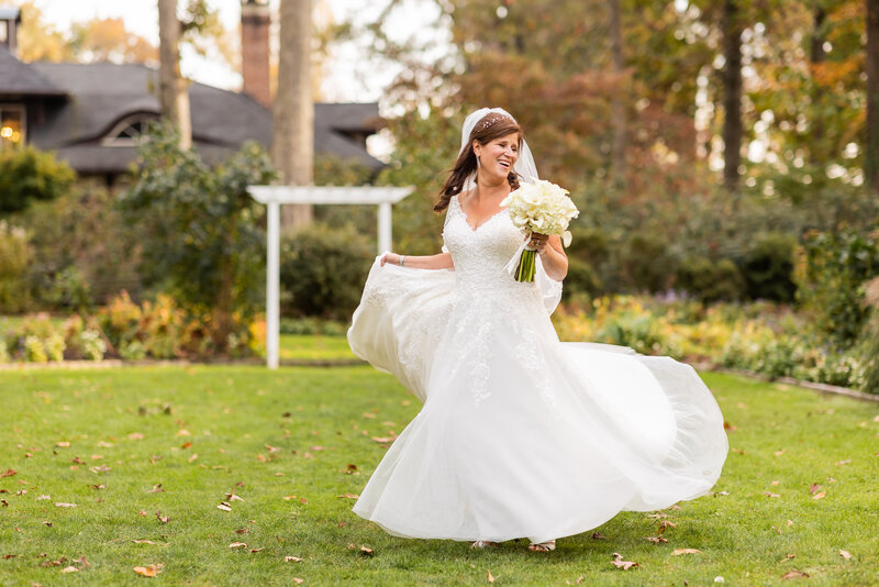 Joyful bride twirls in her wedding gown at Gramercy Mansion, Maryland Wedding Photography