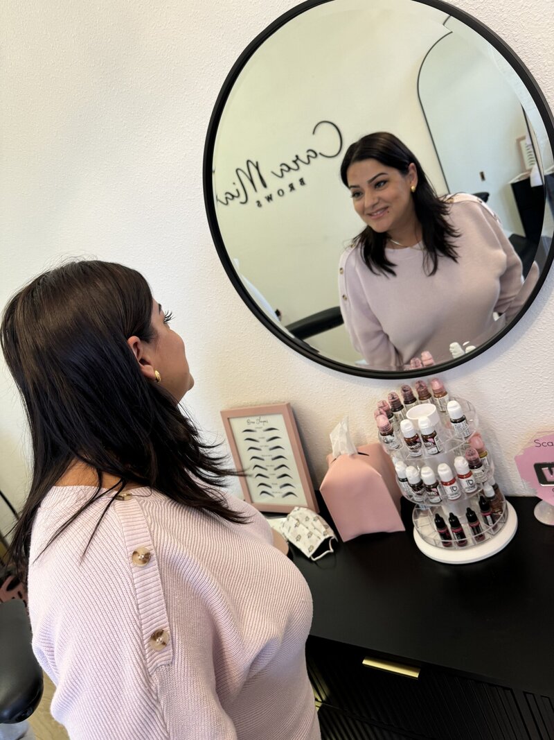 Woman looking at herself in the mirror
