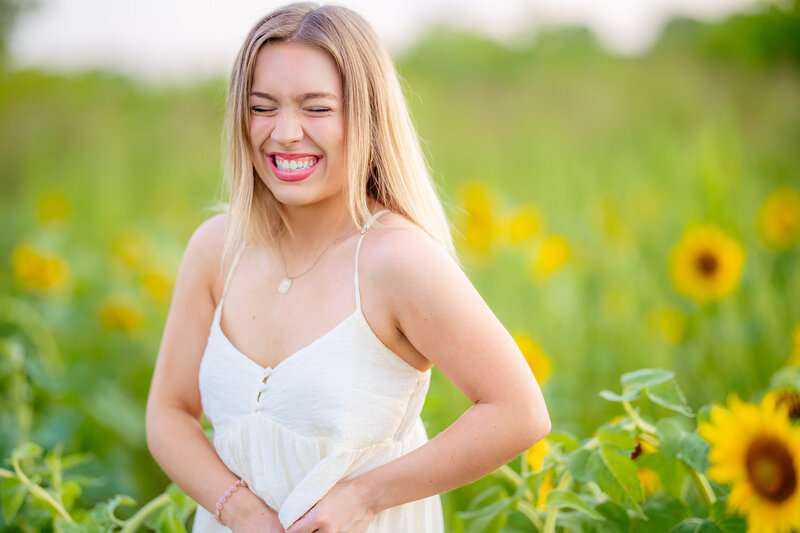 Marin laughing in a sunflower field in St. Louis MO