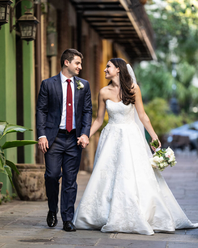 Bride and groom walk through Exchange Place in New Orleans