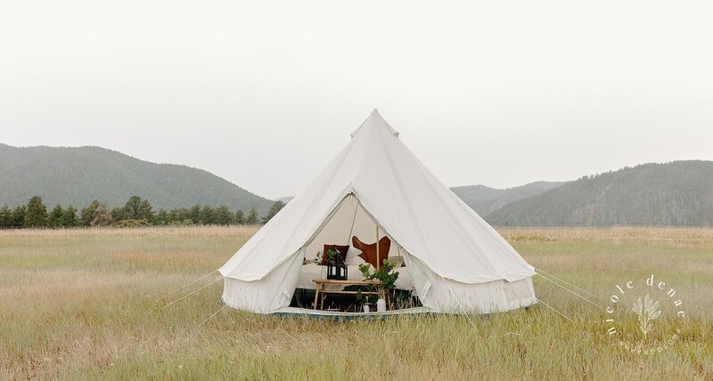 White Canvas Bell Tent Exterior view with partial view of beds and decorations