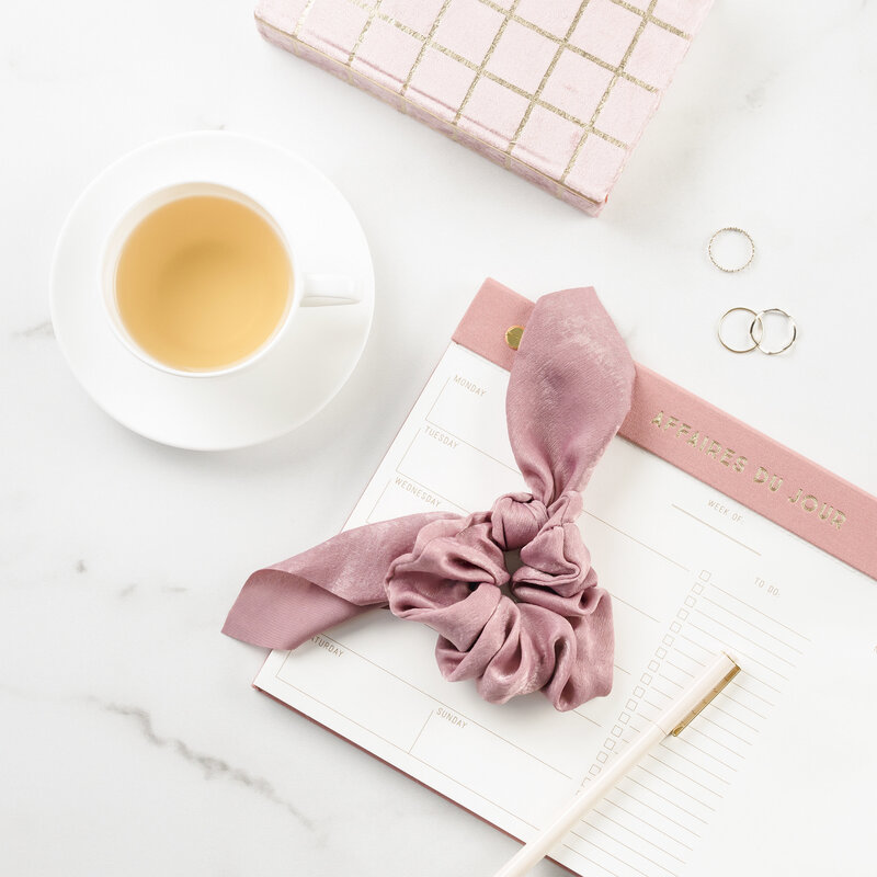 Tea and hair tie on desk