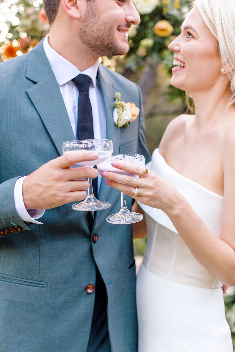 Bride and groom toast with champagne coupes