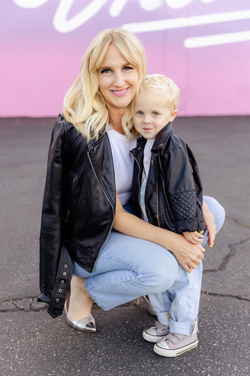 photo of mom with toddler son wearing matching black leather jackets