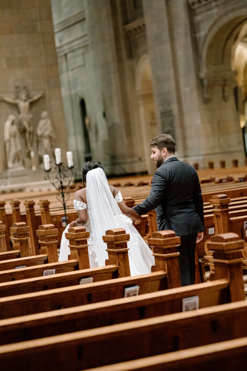 bride and groom walking down the aisle at the Basilica of St Mary's in Minneapolis MN