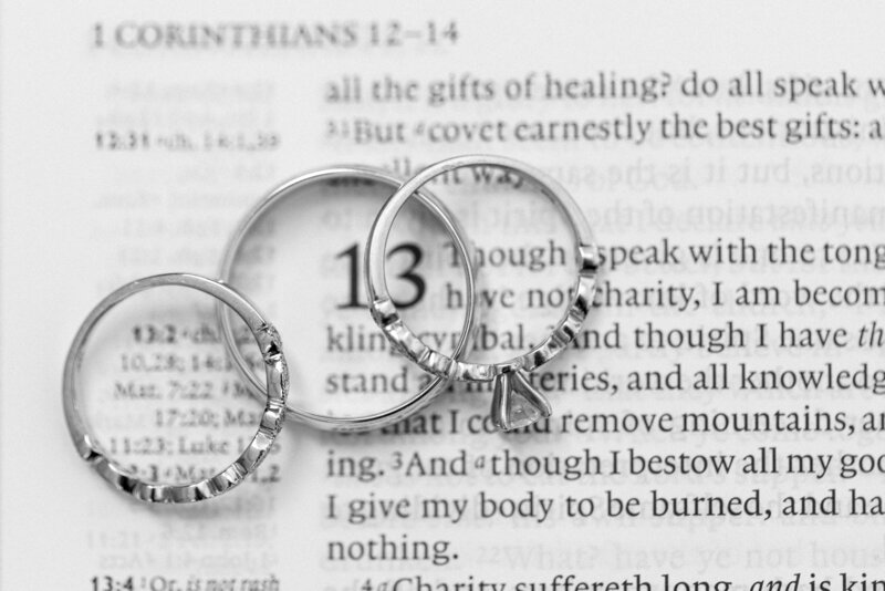 wedding ring set on top of 1 corinthians 13 in the king james bible