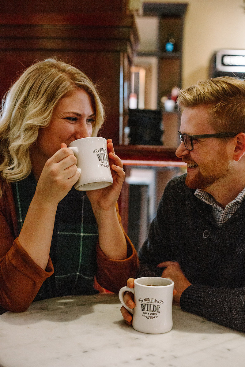 Couple drinking coffee together during their Minneapolis engagement session