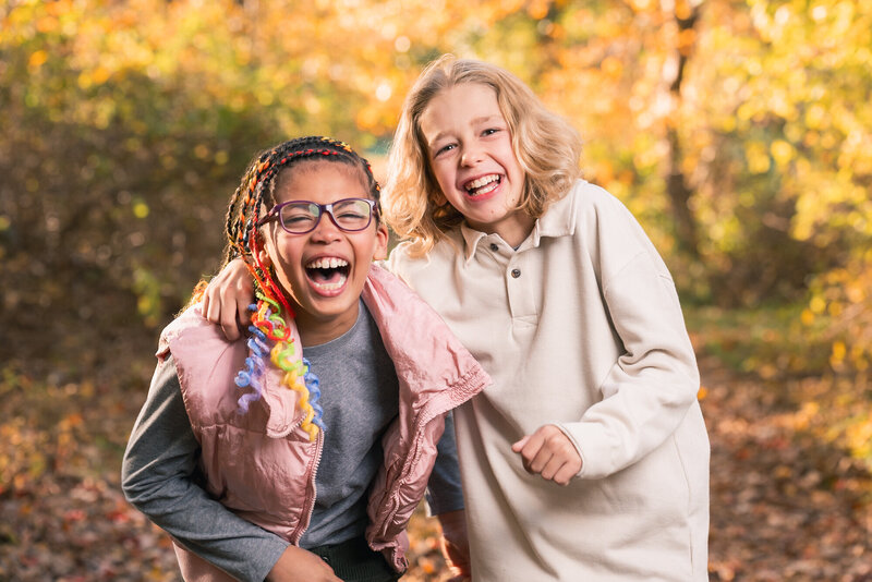 Sibilings laughing with fall colors