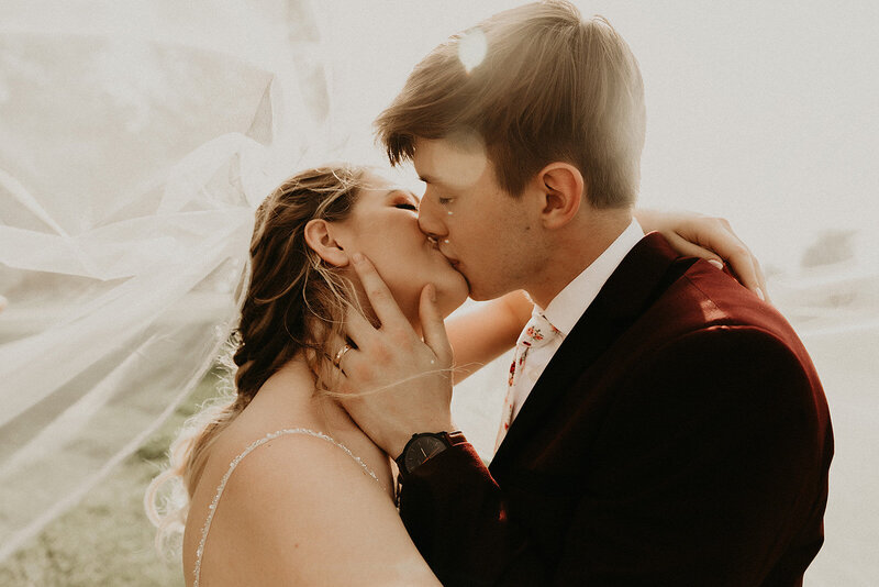 Bride and groom kissing on their wedding day