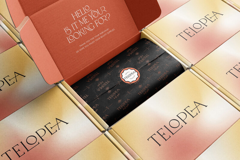 An elegantly designed gift box for Telopea Beauty Supplies, featuring personalized black tissue paper sealed with a branded sticker. The packaging reflects the brand’s luxurious and thoughtful presentation.